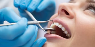 Image of a smiling woman having her teeth worked on
